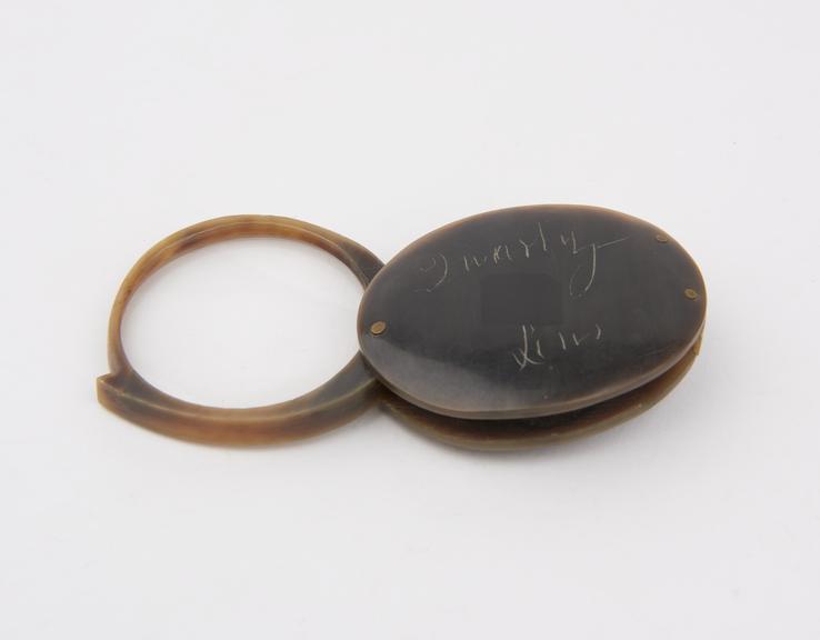 Folding hand glass or magnifier with rounded shape, unsigned