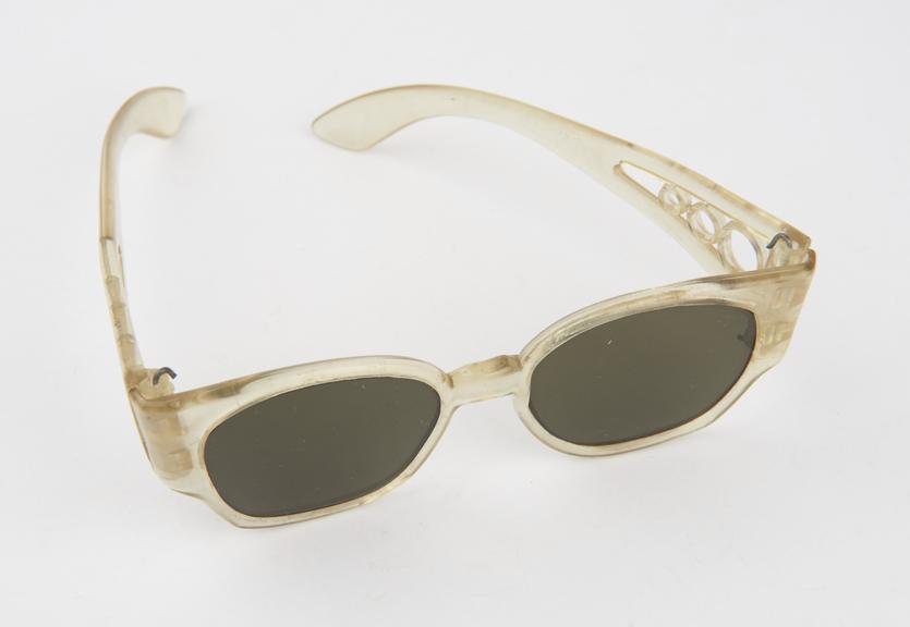 Pair of dark tinted sun glasses with transparent plastic frames