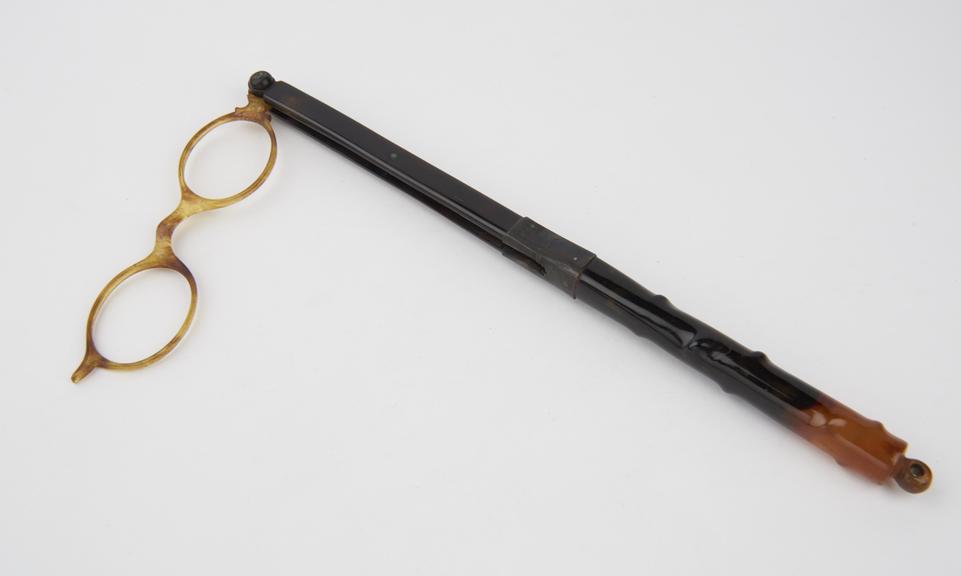 Plastic long handled lorgnette spectacles with oval frames