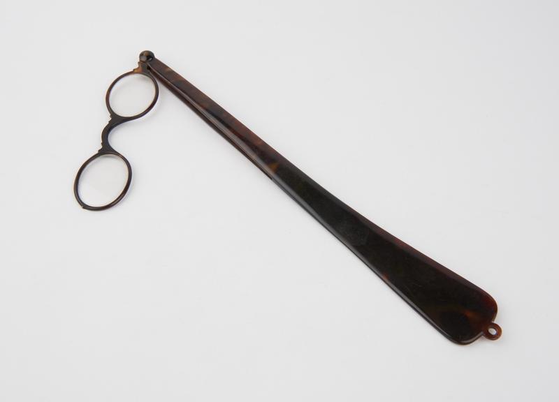 Plastic flat long handled lorgnette spectacles with oval frames