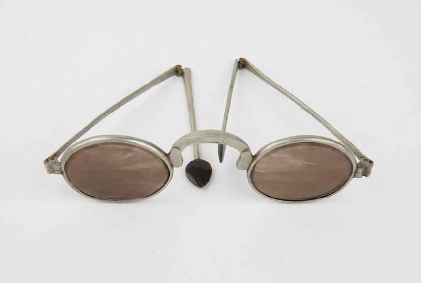 Pair of smoked quartz spectacles in metal frame with folding