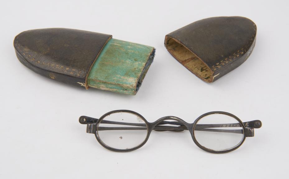 Pair of silver-rimmed spectacles with folding arms with loops