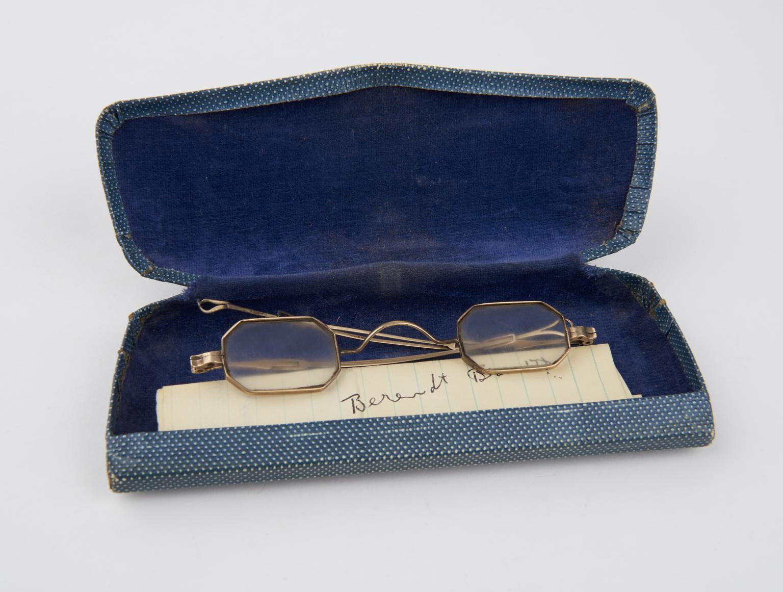 Pair of spectacles with octagonal gold frames and extendable arms in ...