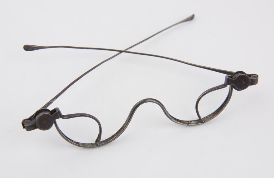 One of four blued steel opticians eye-test lens holders