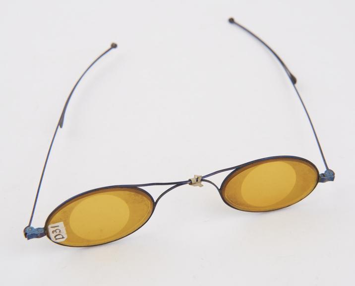 Spectacles (c.1840), thin blue steel frames, yellow glass lenses