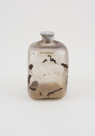 Glass bottle, cork bung, label worn away