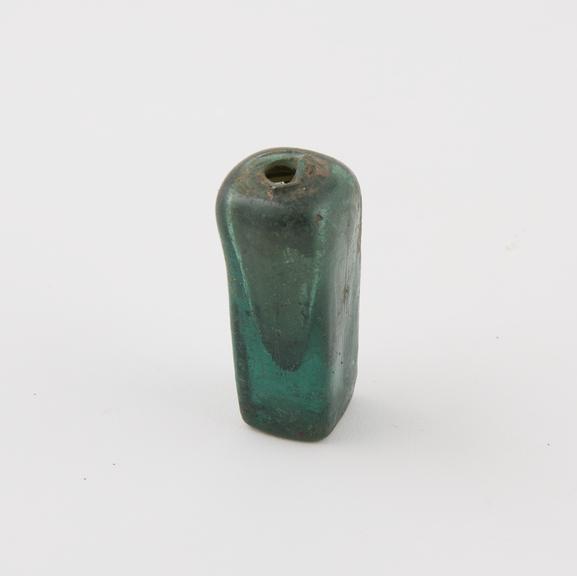 Dark green bottle, square in section, pyramid shaped interior