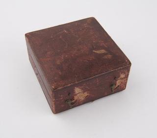 Velvet-lined burgandy leather box for dynameter with handwriten note