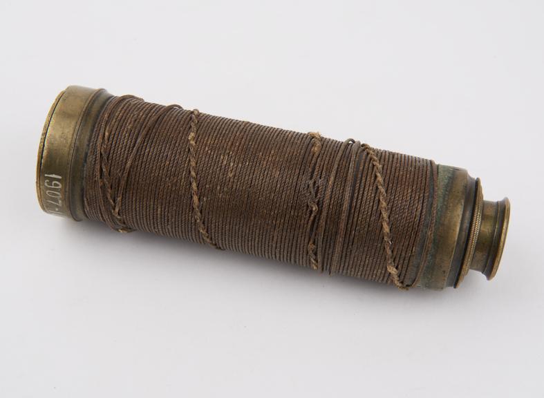 Spyglass hand telescope with brass body and braided string grip