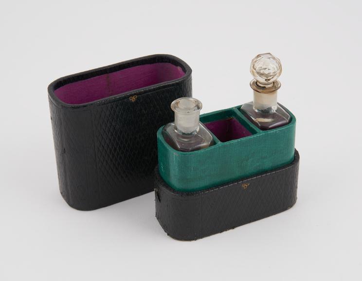 Two glass bottles in leather covered case, by H