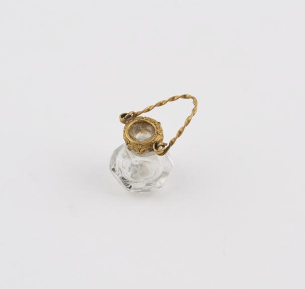 Cut-glass miniature perfume bottle, with faceted oval body
