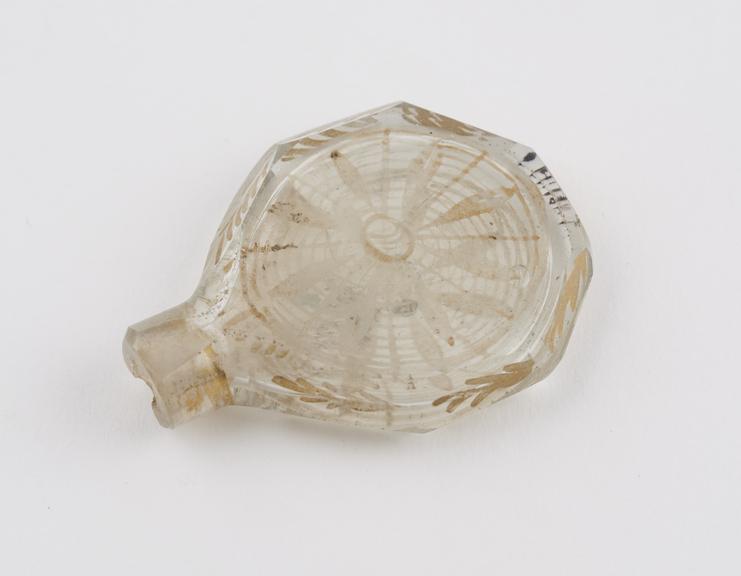 Glass perfume bottle, colourless, disc-shaped body