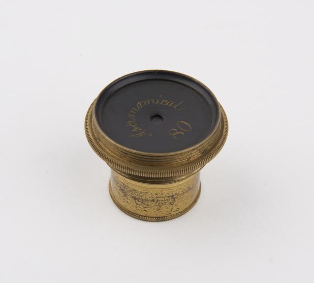 Lens in brass holder, marked  Astronomical 80