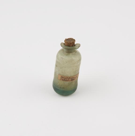 Small green glass bottle, cylindrical