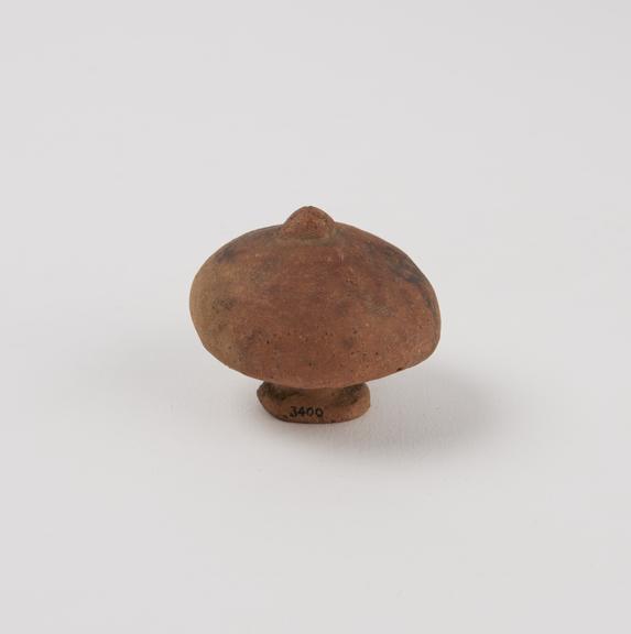 Votive offering in form of either a breast or a mushroom