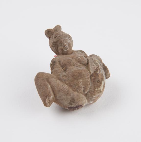 Unglazed hollow terracotta fertility figure with traces of