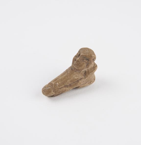 Moulded earthenware faience figure kneeling male supporting