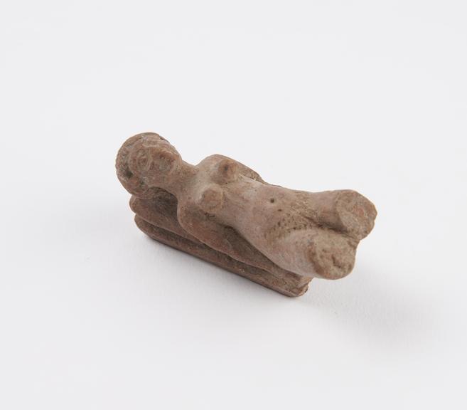 Terracotta figure of reclining woman in erotic pose, damaged