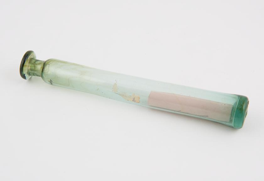 Green glass phial, elongated cylindrical shape