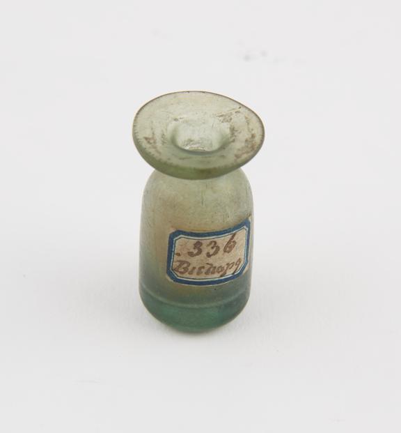 Small cylindrical green glass bottle