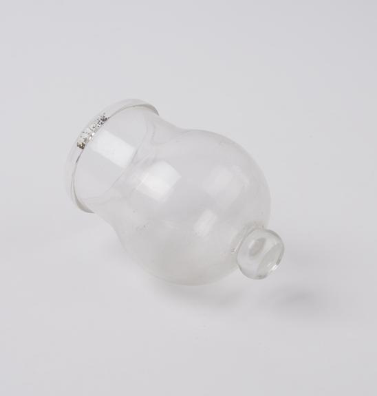 Clear glass bleeding cup with solid glass knob at base