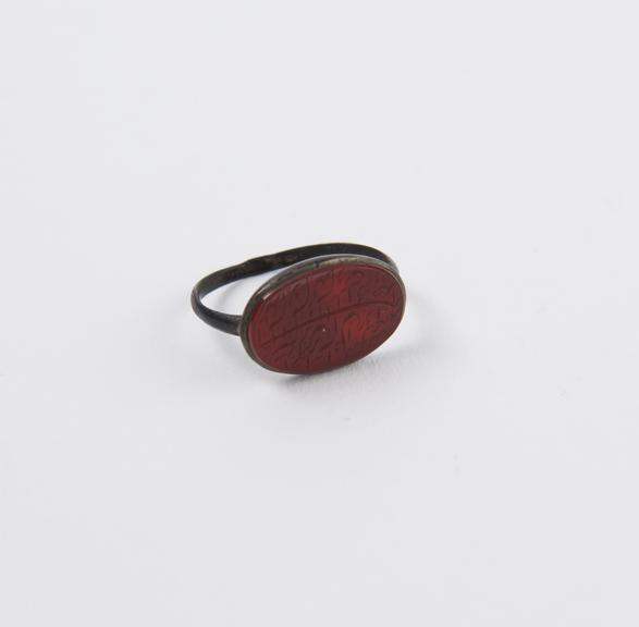 Metal finger ring with red stone