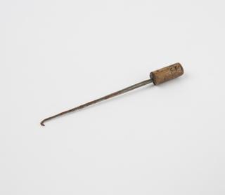 Surgical instrument consisting of steel point hooked at end set into cylindrical handle