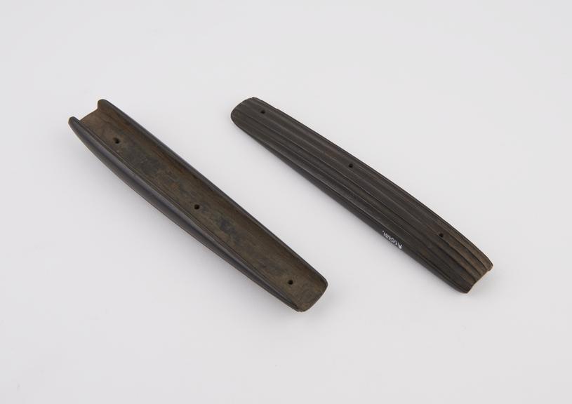 Two fluted wood strips, backing for handles