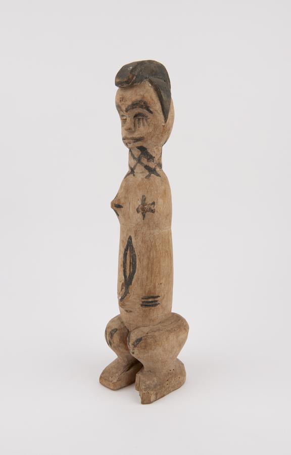 Carved wooden statue of stylized human figure presumably female