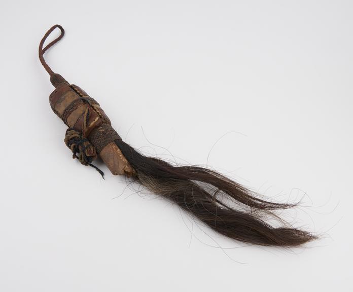 Horse hair fly whisk with leather bound handle containing