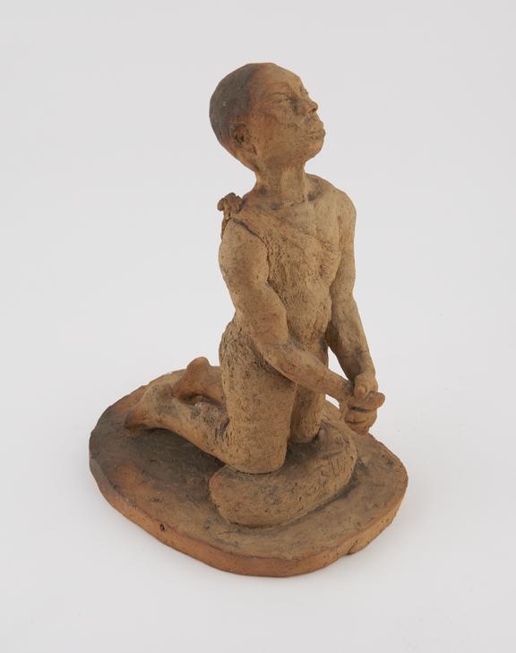 Earthenware sculpture of an African christian