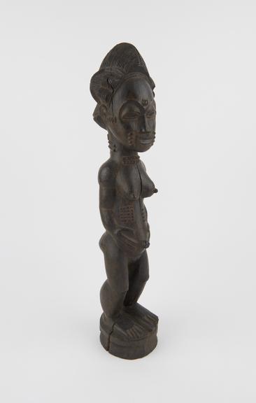 Carved wooden ancestral figure of female standing position with