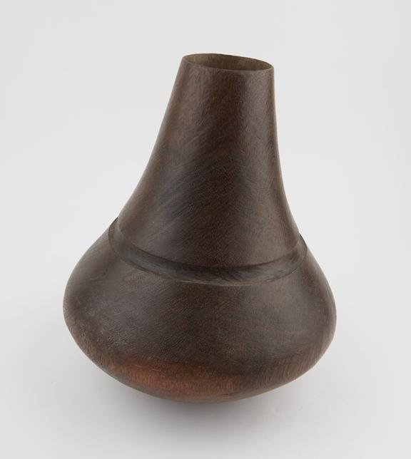 Heavy wooden vessel, gourd shaped with circular mouth