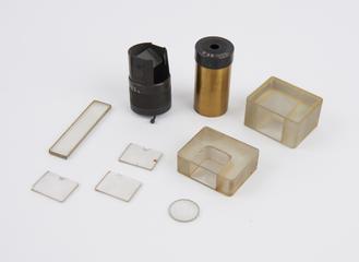 Two brass eyepieces and seven glass components, from Groth's universal apparatus