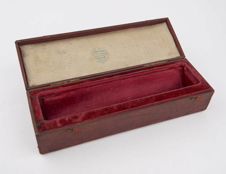 Red leather covered wooden case with silk and velvet lining for