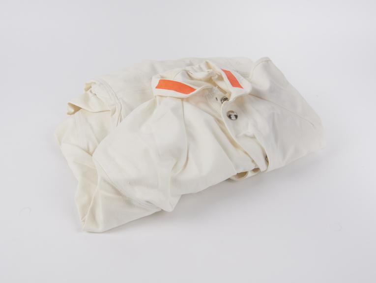 White cotton coverall with popstud fastenings, size 34T