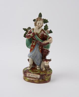 Earthenware statue depicting Saint Luke reading a book