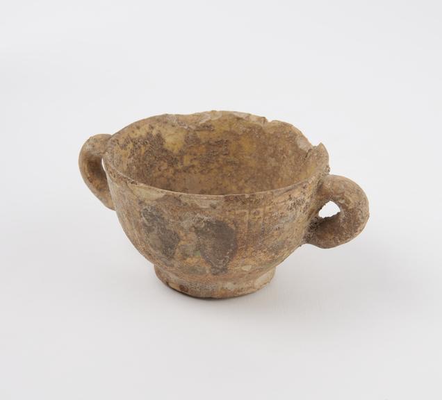 Cup, glazed, two handled, with incised and painted pattern