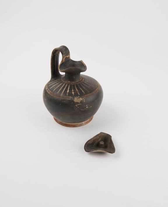 Black glazed oenochoe with ovoid body and trefoil mouth and lid