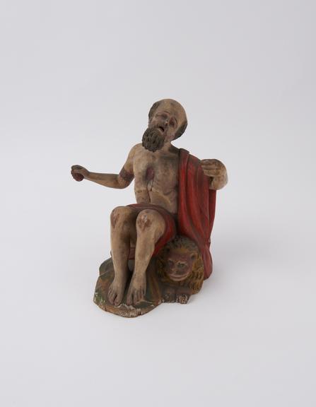 Wooden figure of Saint Jerome performing corporal acts of