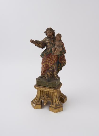 Wooden statue of Saint Joseph holding Christ child