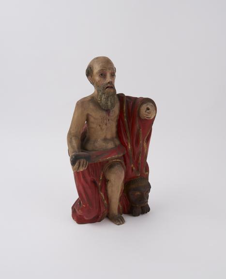 Wooden figure of Saint Jerome performing corporal acts of