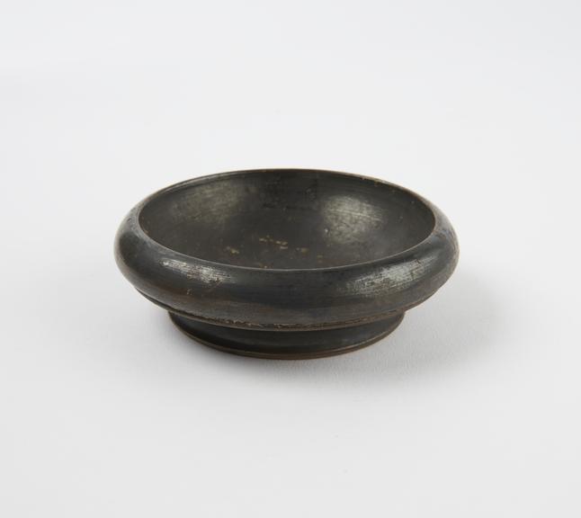 Small shallow black glazed dish