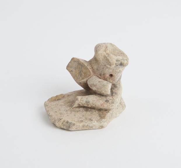 Solid pottery figure of reclining phallic male