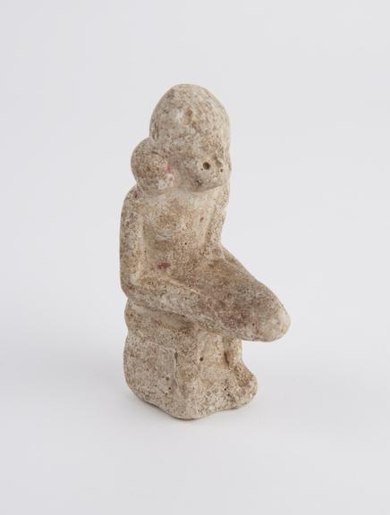 Limestone seated phallic figure with serpent round neck (statue)