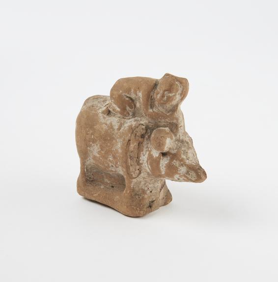 Small figure of child on pig