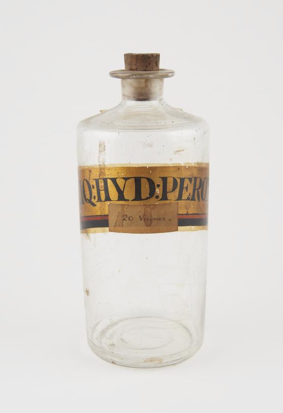 Bottle, clear glass, with contents