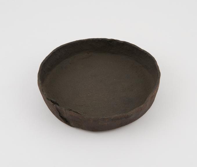 Flat metal bowl, in poor condition, probably English, 1800-1900