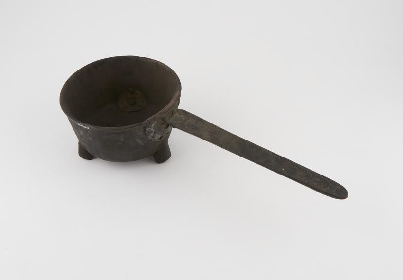 Circular pan, with three legs and long inscribed handle