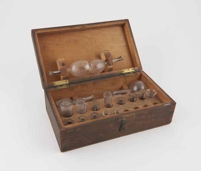 18 apothecary's glass measures in wooden case